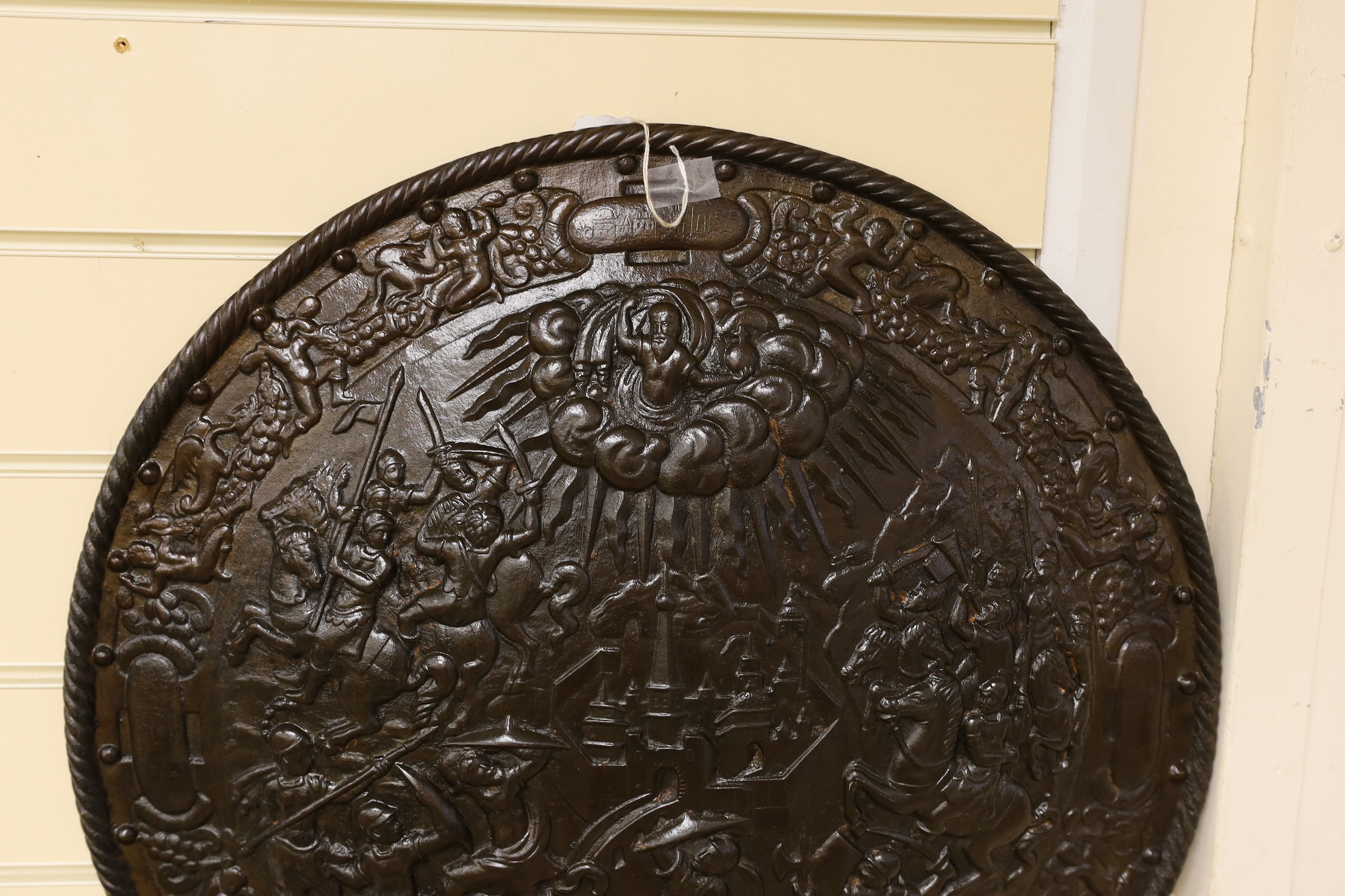 A Victorian cast iron shield shaped wall plaque, 55cms diameter.